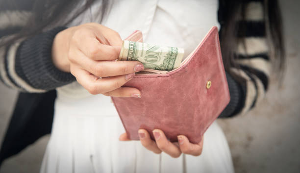 istock Woman hands with wallet and money. 1404852920
