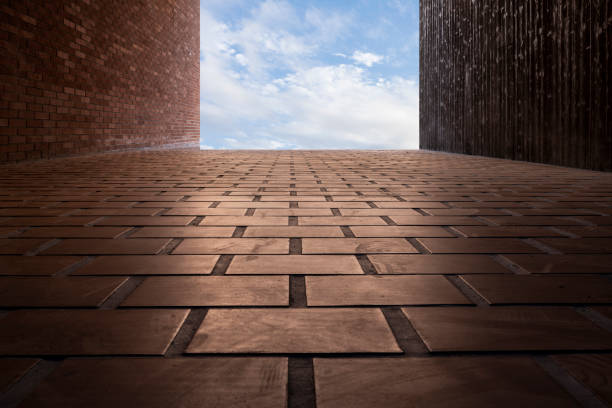 Low angle view of brick house under blue sky and white clouds