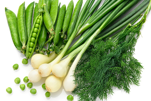 fresh vegetables - a bunch of green onions, dill and peas in detail, the object is highlighted on a white background, the concept and healthy nutrition