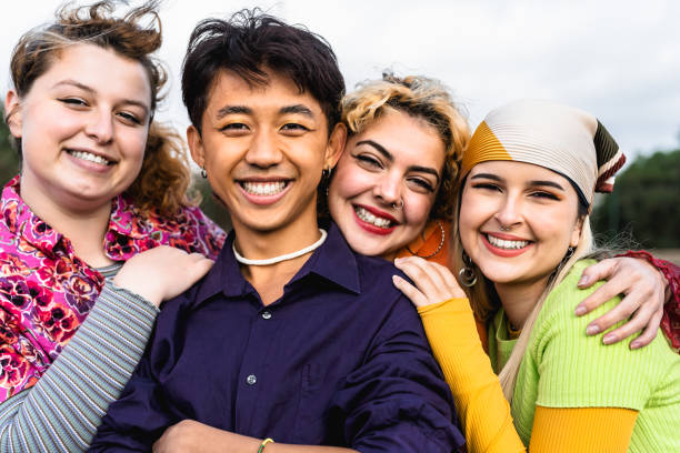 Happy young diverse friends having fun hanging out together - Youth people millennial generation concept stock photo
