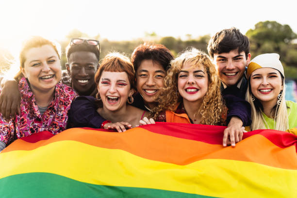 Diverse young friends celebrating gay pride festival - LGBTQ community concept stock photo