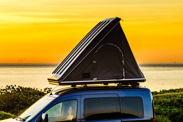 istock Car with roof top tent camp on beach 1404854608