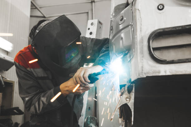 istock Male in face mask welds with carbon dioxide welding 1404854770