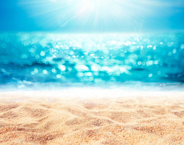 Sand And Sea - Beach Summer With Defocused Ocean and Bokeh Lights - Abstract Blurred Seashore stock photo
