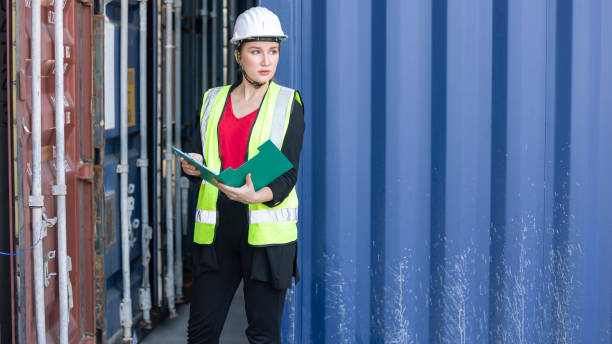 istock Young female logistics worker and blue container 1404859034
