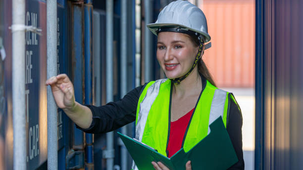 istock Young female logistics worker and blue container 1404859036