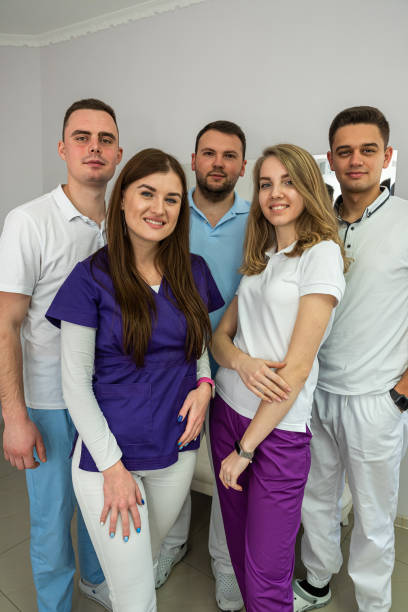 istock Five young promising experienced masters of dentists pose in the hallway. 1404859070