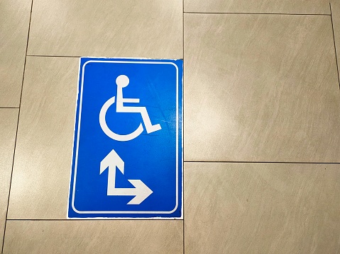 Sign on floor in building. Universal design for all people.