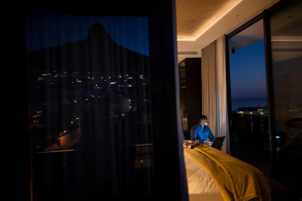 istock Businessman working late looking out window 1404861070