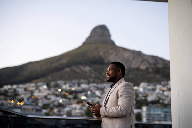 istock Businessman on balcony looking up to view 1404861195