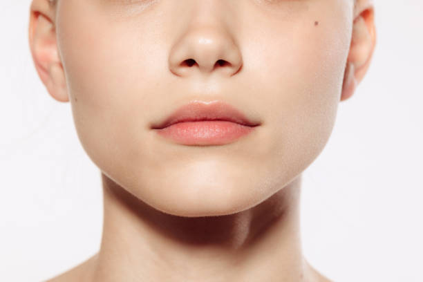 istock Closeup female lips, cheeks and nose isolated over white studio background. Concept of cosmetology, skincare, cosmetics, plastic surgery, ad 1404862932