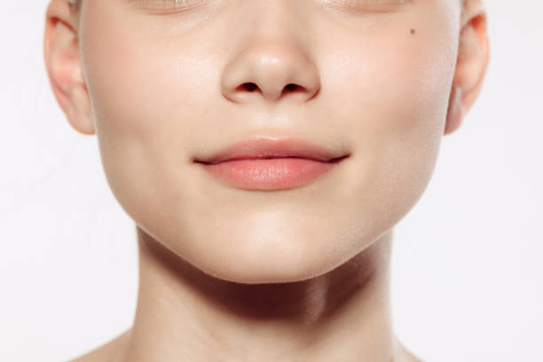 istock Closeup female lips, cheeks and nose isolated over white studio background. Concept of cosmetology, skincare, cosmetics, plastic surgery, ad 1404862940