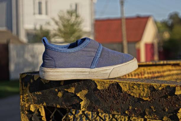 istock one blue sneaker made of fabric with a white sole 1404863116
