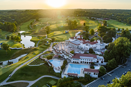 Bethesda, MD, USA - June 21, 2022: Aerial shot of the Congressional Country Club just before the LPGA Championship tournament, captured at golden hour showing the clubhouse and grounds with the sunset in the background. The image was captured by Nathanael Showalter of Hover Solutions, LLC operating a DJI Inspire 2 under the terms of a TSA waiver for the airspace.