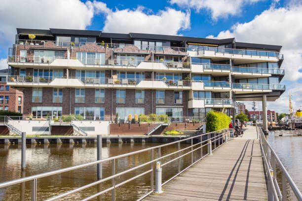 istock Wooden bridge and modern apartment building in Emden 1404864286