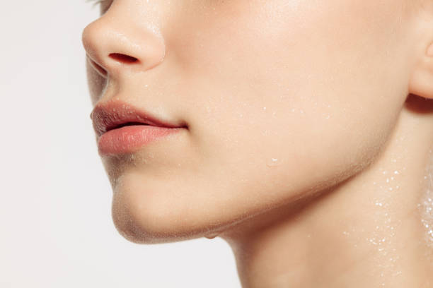istock Closeup female lips, cheeks and nose isolated over white studio background. Concept of cosmetology, skincare, cosmetics, plastic surgery, ad 1404864315