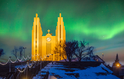 The church in Akureyri in northern Iceland, illuminated, early in the evening with aurora boralis