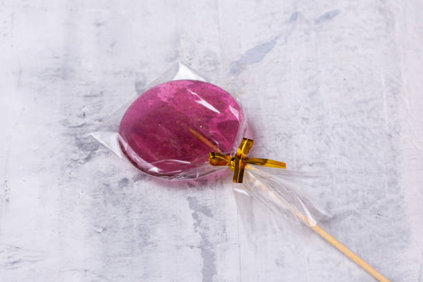 istock Pink lollipop on a textured background 1404864631