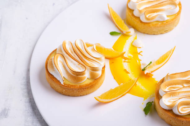 istock Appetizing lemon tartlets with meringue served on a white plate 1404865969