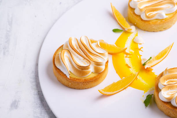 istock Appetizing lemon tartlets with meringue served on a white plate 1404866567
