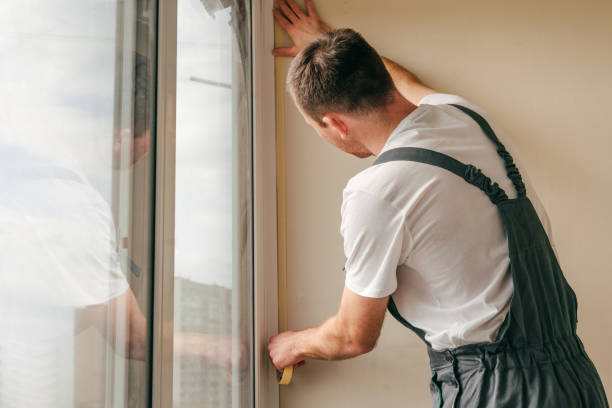 istock Young man applying mounting tape before sealing a window 1404866676
