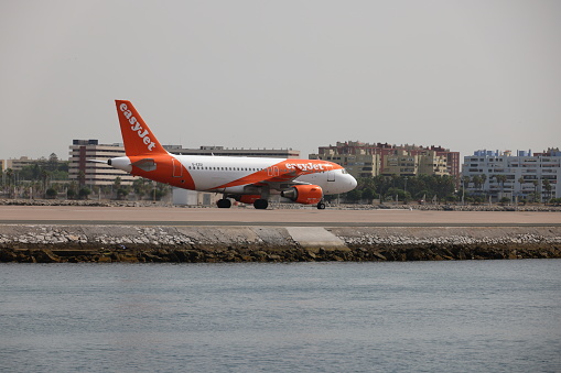 Gibraltar - 16th June, 2022: Easyjet aircraft taxis on the Gibraltar airstrip that protrudes into the sea. Gibraltar is a British Overseas Territory