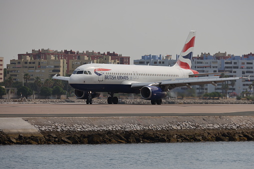 Gibraltar - 16th June, 2022: British Airways aircraft taxis on the Gibraltar airstrip that protrudes into the sea. Gibraltar is a British Overseas Territory