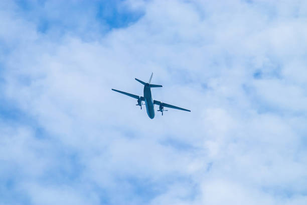 istock Airplane in blue sky. Air cargo transportation. Plane is flying 1404867266