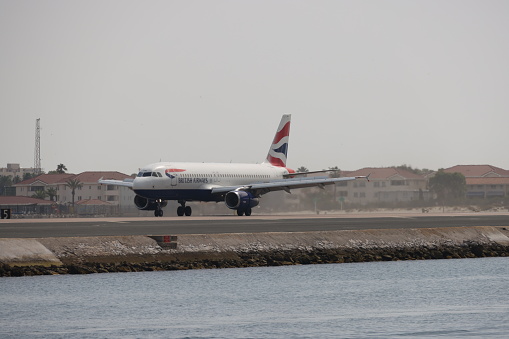 Gibraltar - 16th June, 2022: British Airways aircraft taxis on the Gibraltar airstrip that protrudes into the sea. Gibraltar is a British Overseas Territory