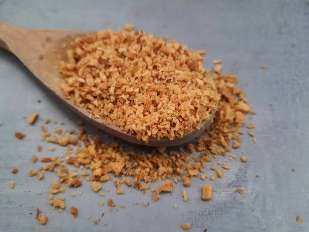 istock Garlic (allium) fried in a wooden spoon. 1404868511