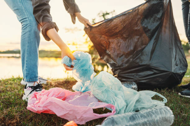 istock woman hand picking up garbage plastic for cleaning at park 1404870551
