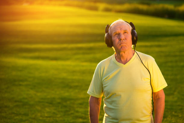 istock Elderly man in headphones. 1404871983