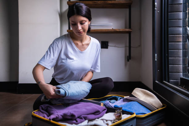 istock young and modern woman packing suitcase 1404872629