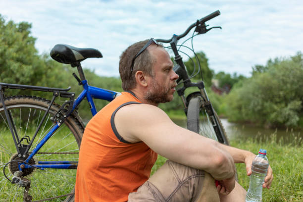 45 year old Man takes a break from his bike ride