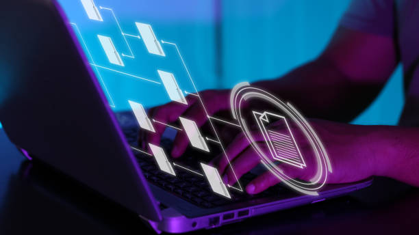 istock User working on laptop with virtual screen of Document Management System (DMS), a virtual online documentation database. Concept for business and office management. Selective focus. 1404876285