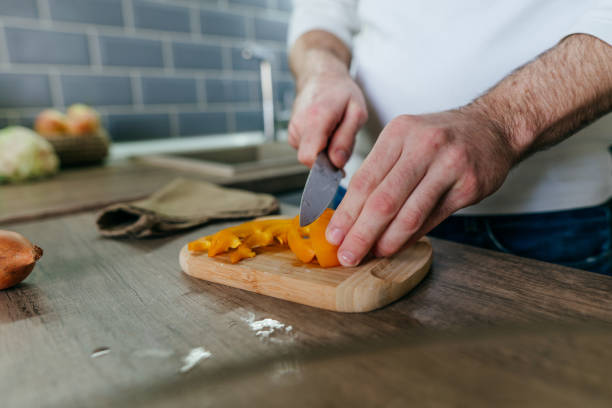 istock Unrecognizable man cooking vegetables in the kitchen 1404877694