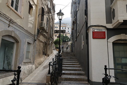 Gibraltar - 16th June, 2022: Quaint old backstreets of Gibraltar with steps leading up to the Gibraltar nature reserve and the Rock of Gibraltar