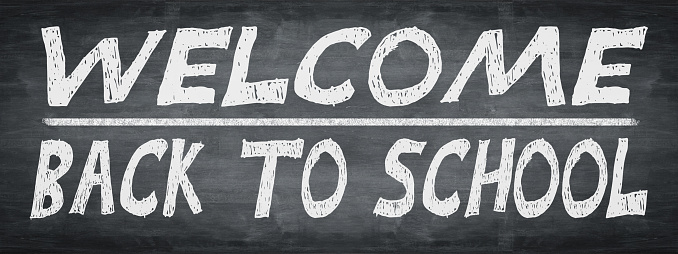 SCHOOL BEGINNING Background banner panorama - Old rustic school blackboard, chalkboard with handlettering: WELCOME BACK TO SCHOOL