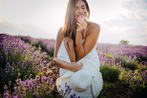 Relaxing moments. Woman in lavender field at sunset.
