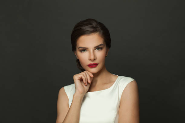 istock Glamourous brunette woman model with fresh makeup, red lips and dark eyebrows 1404884832