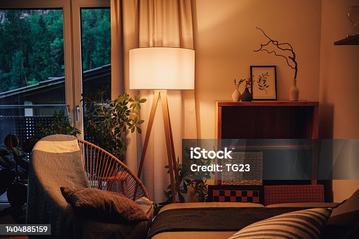 istock View of tripod lamp in a cozy living room spending warm light 1404885159