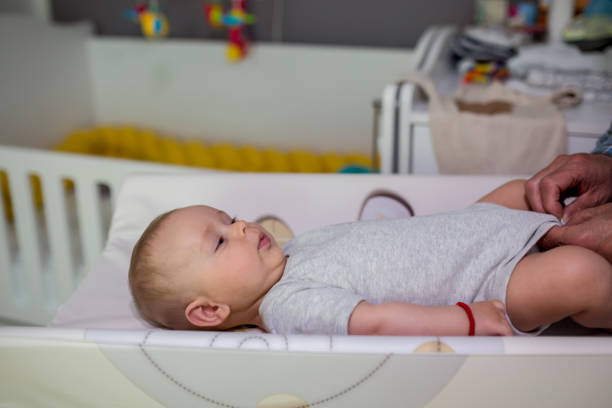 istock Grandfather Changing Diaper To His grandchild 1404885621