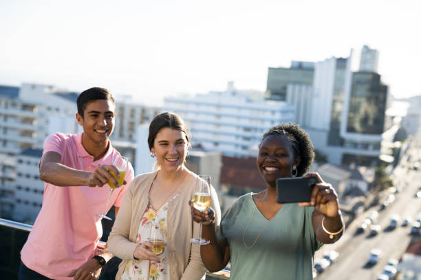 istock Friends taking selfie enjoying evening overlooking city 1404885624