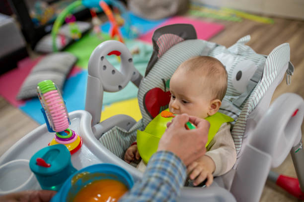 istock Funny baby eating food on kitchen 1404885709