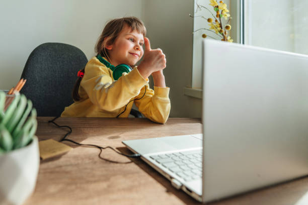 istock Little girl using technology at home indoor 1404887275
