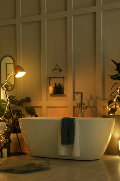 istock Stylish bathroom interior with houseplants and string lights. Home design 1404888282