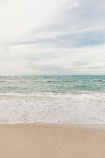 Ocean Waves Splashing Along the Empty Rocky Beach Shoreline at Sunset in Singer Island, Florida in June of 2022