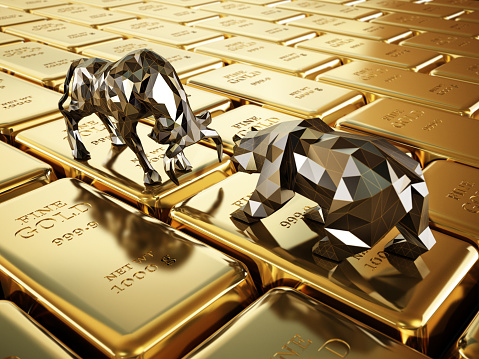 Stylized low poly bull and bear standing and facing each other on gold ingots.