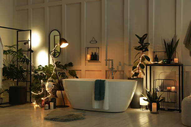 istock Stylish bathroom interior with houseplants and string lights. Home design 1404889342