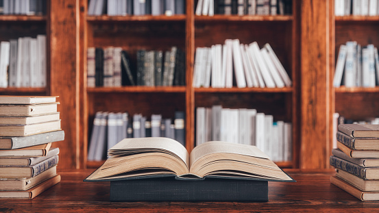 Open book on the desk in a library.